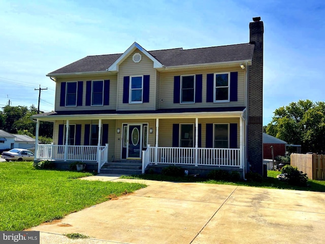 view of front facade with covered porch and a front lawn