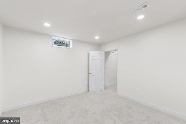 unfurnished room featuring light colored carpet