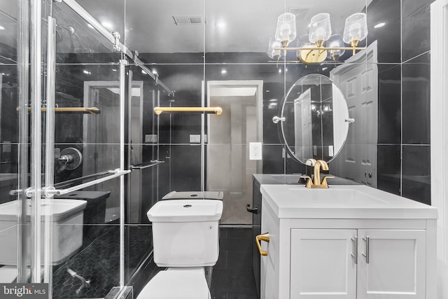 bathroom with vanity, tile walls, and toilet