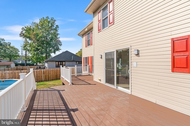 wooden terrace featuring a fenced in pool