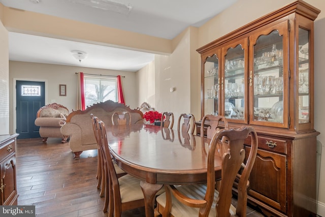 dining area with dark hardwood / wood-style flooring