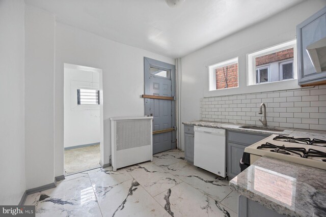 kitchen with gray cabinetry, white appliances, radiator, sink, and decorative backsplash