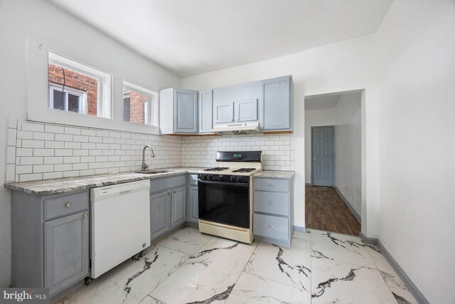 kitchen featuring white appliances, light hardwood / wood-style flooring, backsplash, sink, and gray cabinets