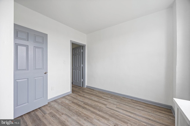 unfurnished bedroom with light wood-type flooring