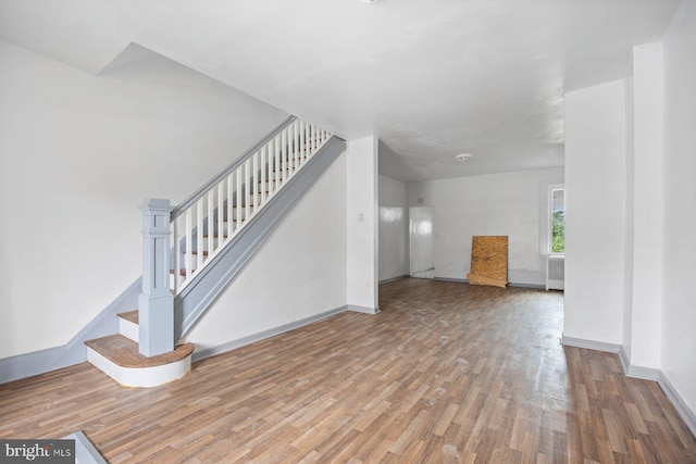 unfurnished living room featuring wood-type flooring