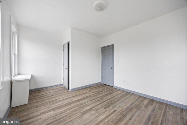 unfurnished bedroom featuring hardwood / wood-style flooring