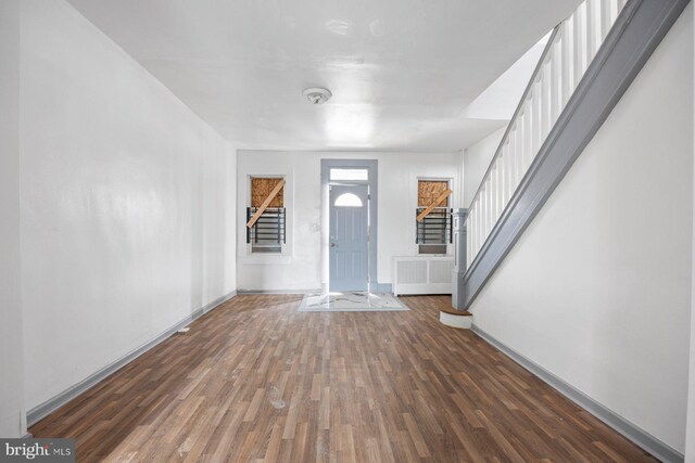 entrance foyer featuring radiator and dark hardwood / wood-style floors