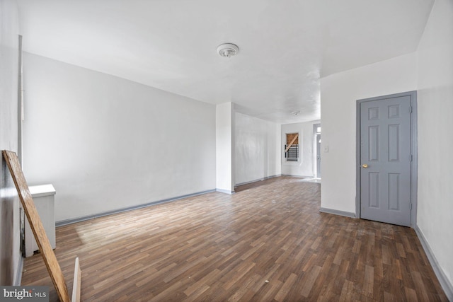 spare room with wood finished floors and baseboards