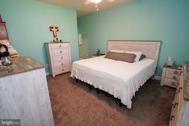 bedroom with ceiling fan and dark colored carpet