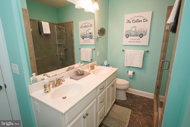 bathroom with vanity, toilet, and a shower with shower door