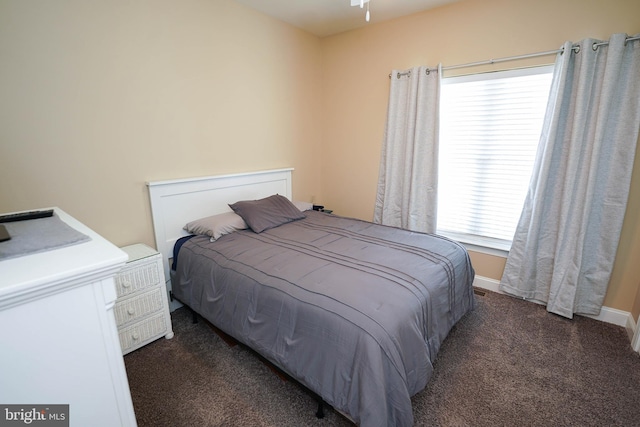 bedroom featuring dark carpet