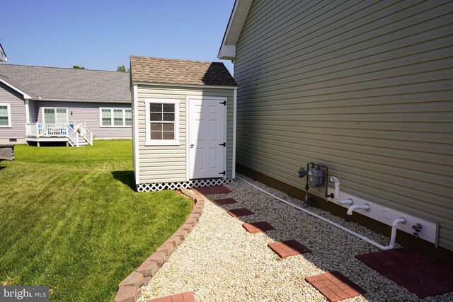 entrance to property with a wooden deck and a lawn