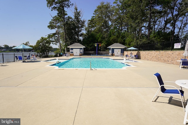 view of swimming pool with an outdoor structure and a patio