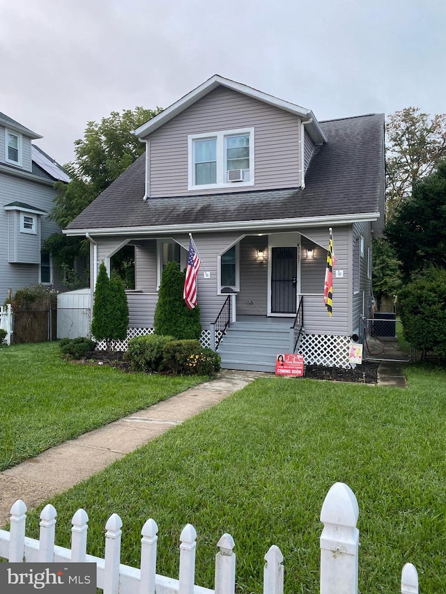 view of front of home with a front yard and a porch