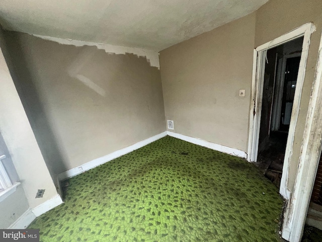 spare room with baseboards