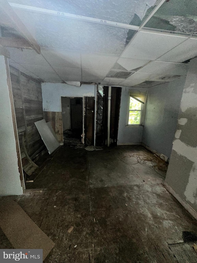 basement featuring a paneled ceiling