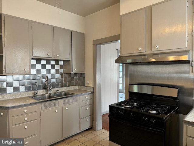 kitchen with backsplash, sink, gray cabinets, black range with gas stovetop, and light tile patterned flooring