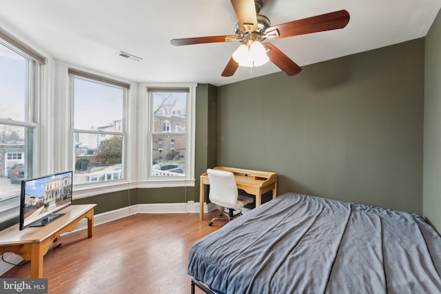 bedroom with hardwood / wood-style flooring and ceiling fan