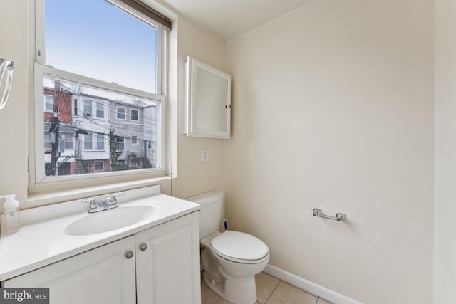 bathroom with tile patterned flooring, vanity, and toilet