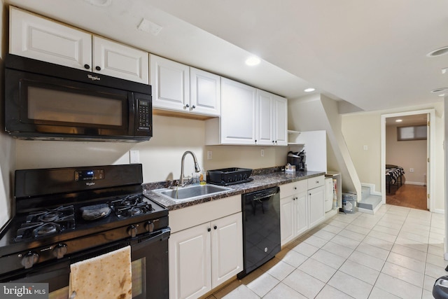 kitchen with black appliances, light tile patterned flooring, white cabinets, and sink