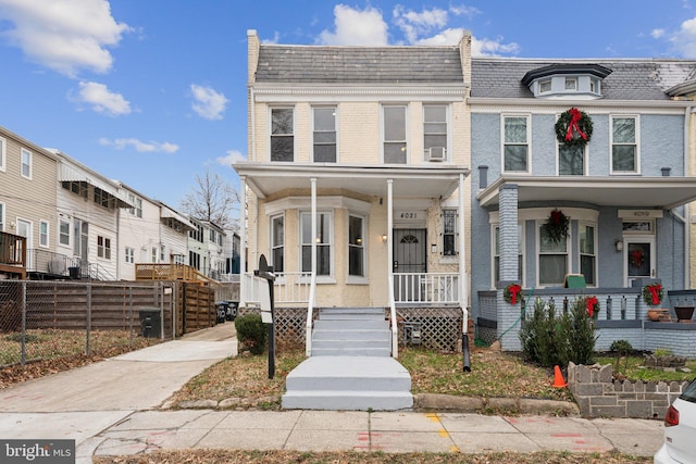 townhome / multi-family property with covered porch