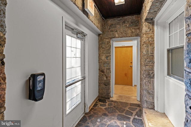 doorway to outside featuring wooden ceiling