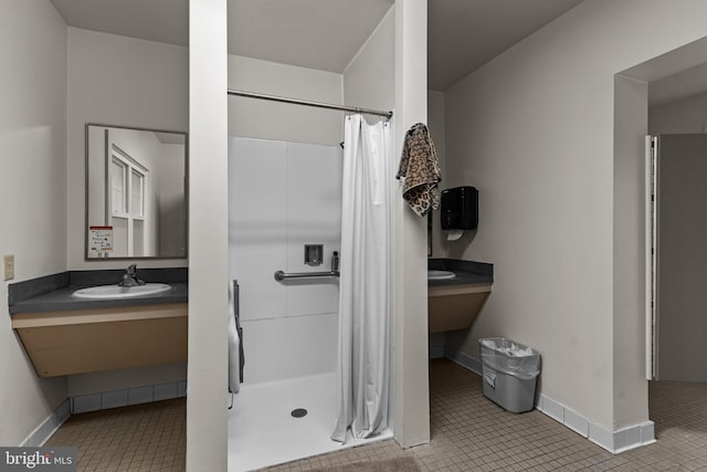 bathroom featuring a shower with curtain, vanity, and tile patterned flooring