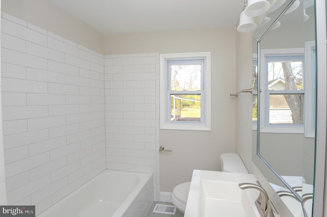 full bathroom with vanity, toilet, and tiled shower / bath combo