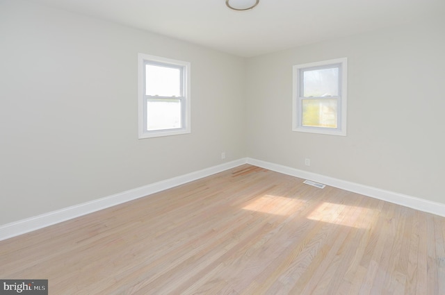 unfurnished room with light wood-type flooring