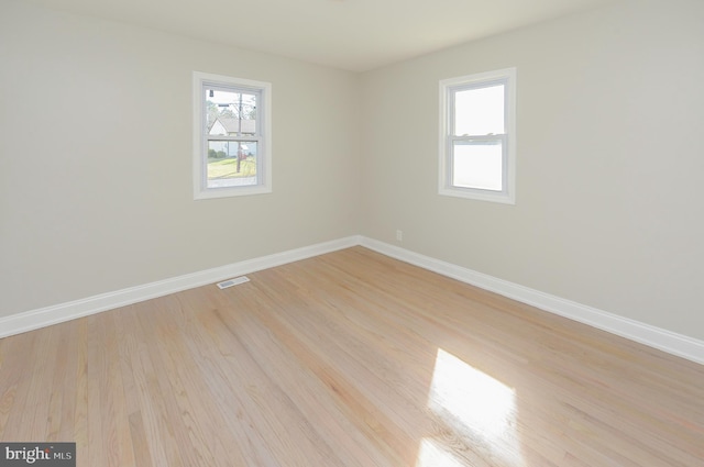 unfurnished room with light wood-type flooring