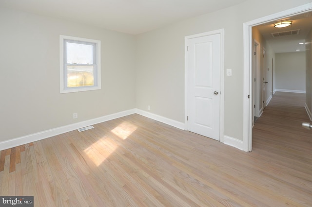 unfurnished room with light hardwood / wood-style floors