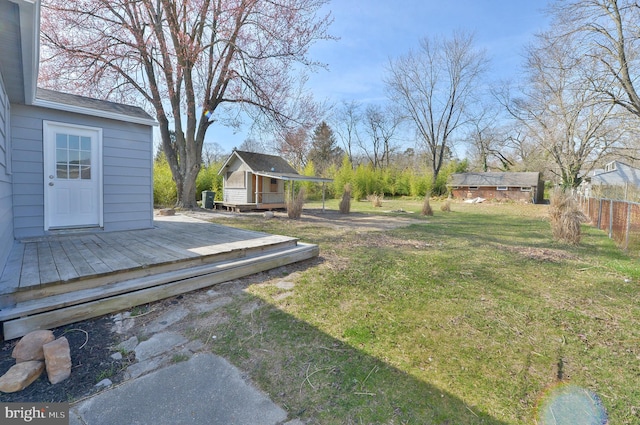 view of yard with an outdoor structure and a deck