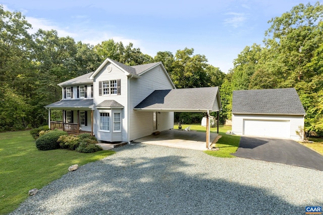 view of front of property featuring a front lawn, a carport, a garage, covered porch, and an outdoor structure