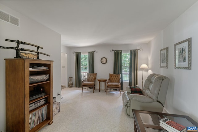 sitting room with a healthy amount of sunlight and carpet floors