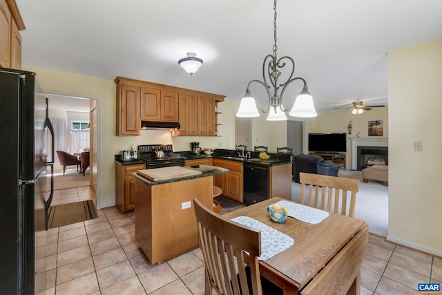 kitchen featuring ceiling fan with notable chandelier, sink, black appliances, light tile patterned flooring, and a kitchen island