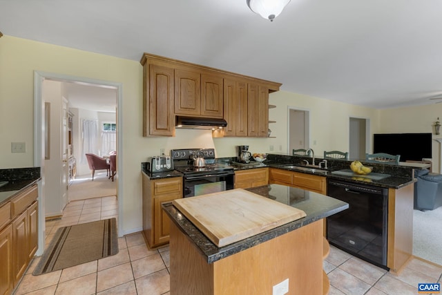 kitchen featuring black appliances, a kitchen island, light tile patterned flooring, and sink