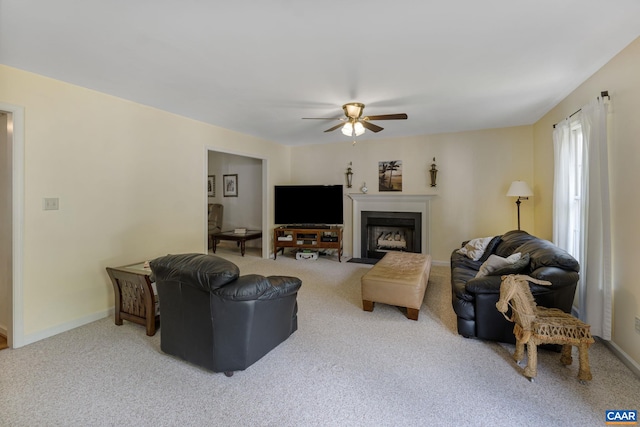 carpeted living room featuring ceiling fan