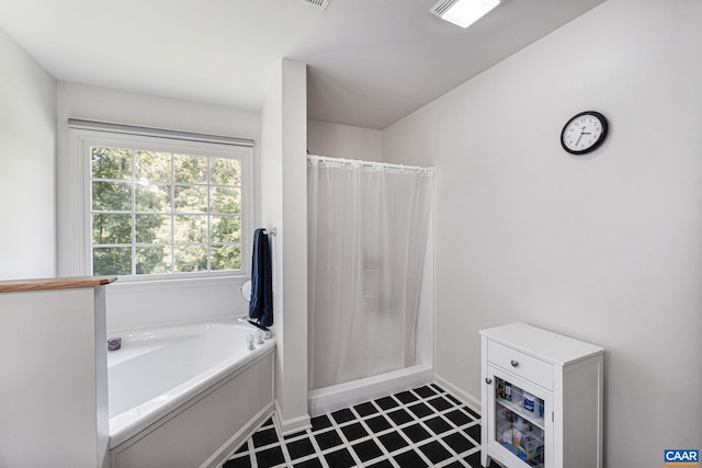 bathroom with separate shower and tub