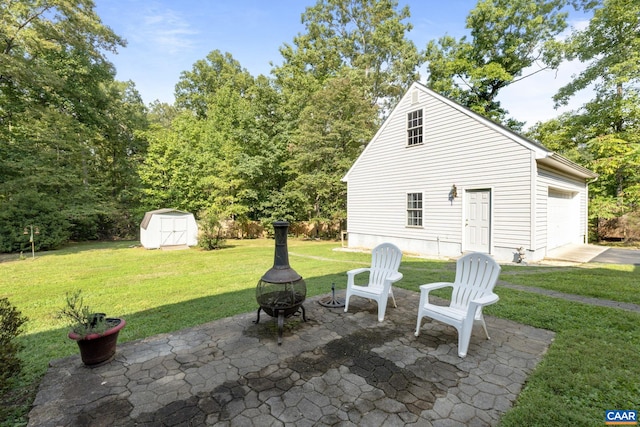 view of patio / terrace featuring a fire pit and a shed