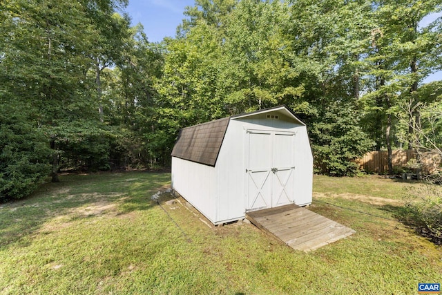 view of outbuilding featuring a lawn