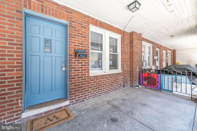 view of exterior entry with a porch