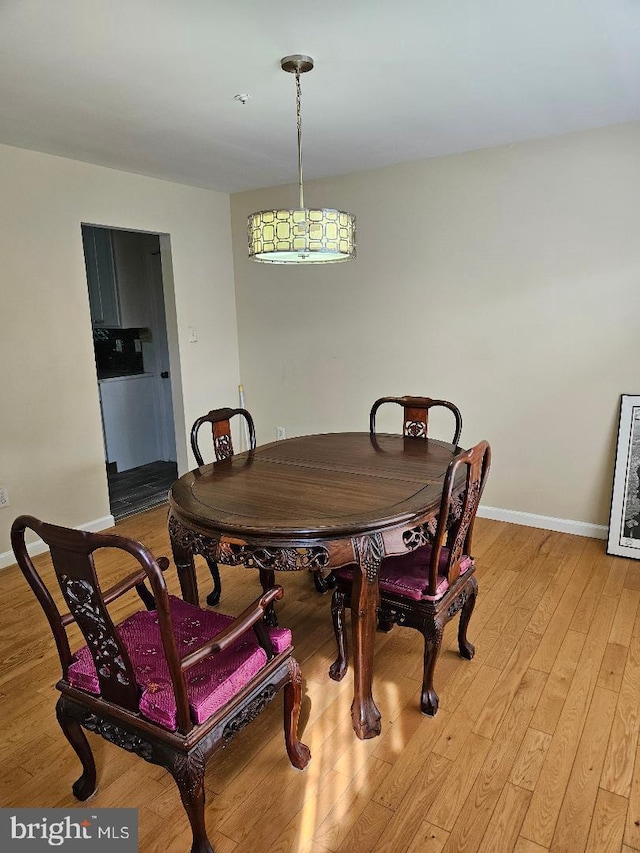 dining room featuring wine cooler and light wood-type flooring