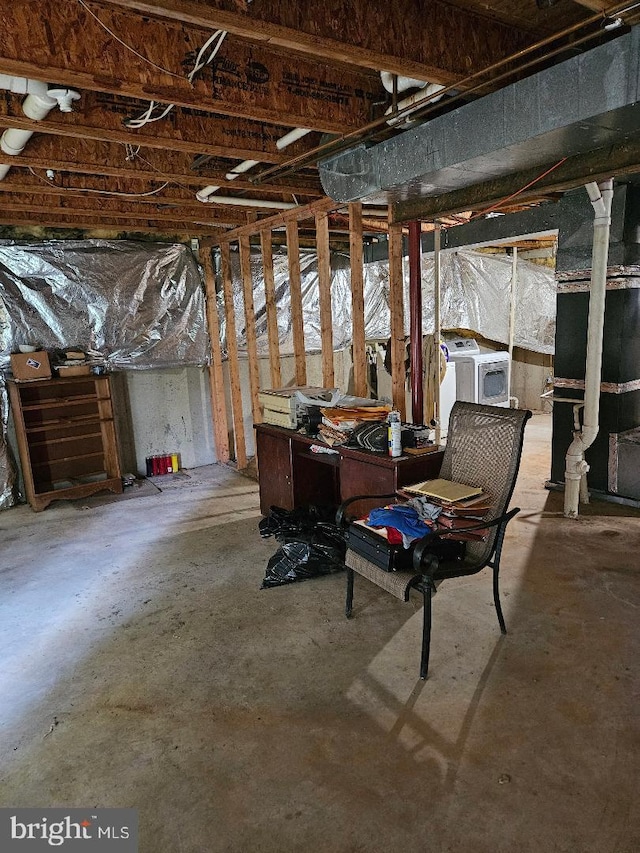 basement with washing machine and clothes dryer and heating unit