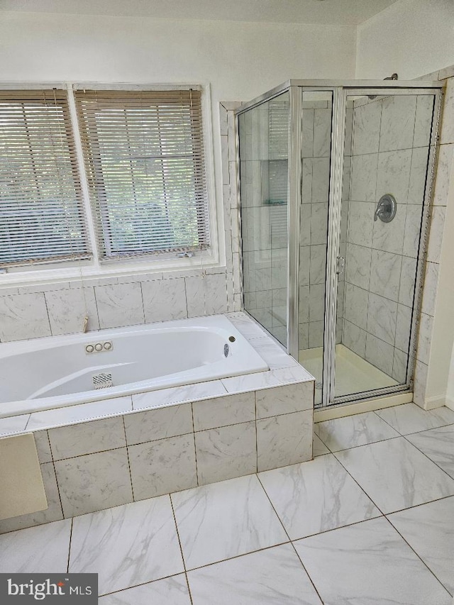 bathroom featuring separate shower and tub