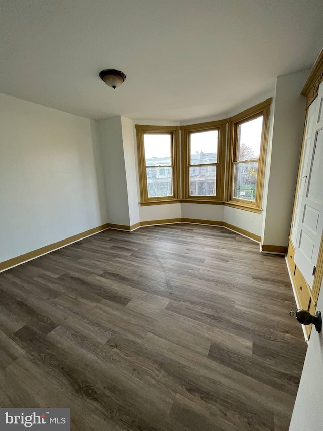 spare room with dark hardwood / wood-style flooring