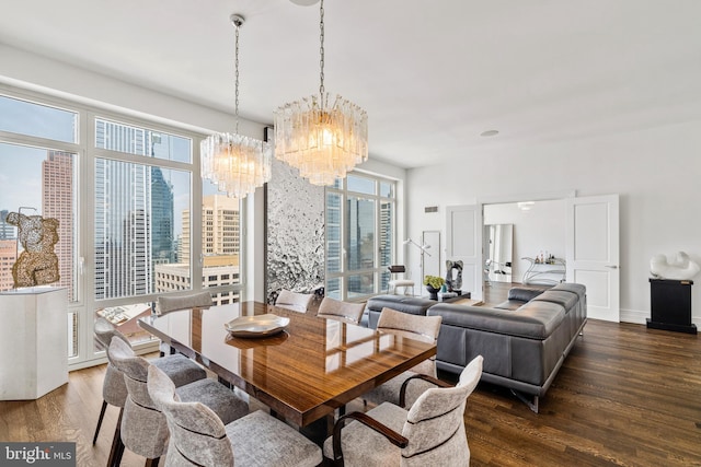 dining space featuring dark hardwood / wood-style floors, a wealth of natural light, and a chandelier