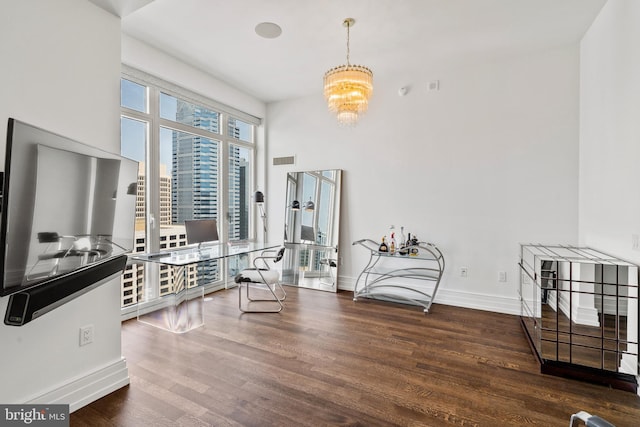 sitting room featuring dark hardwood / wood-style floors and an inviting chandelier