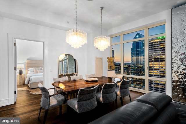 dining area featuring dark hardwood / wood-style flooring and a chandelier