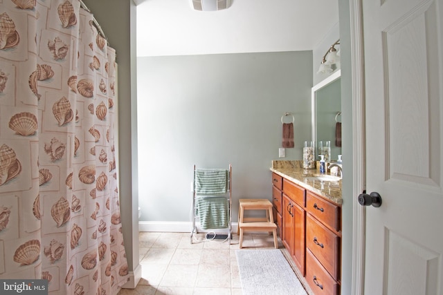 bathroom with baseboards, a shower with curtain, vanity, and tile patterned flooring