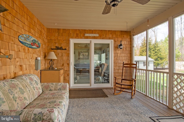 sunroom / solarium featuring ceiling fan